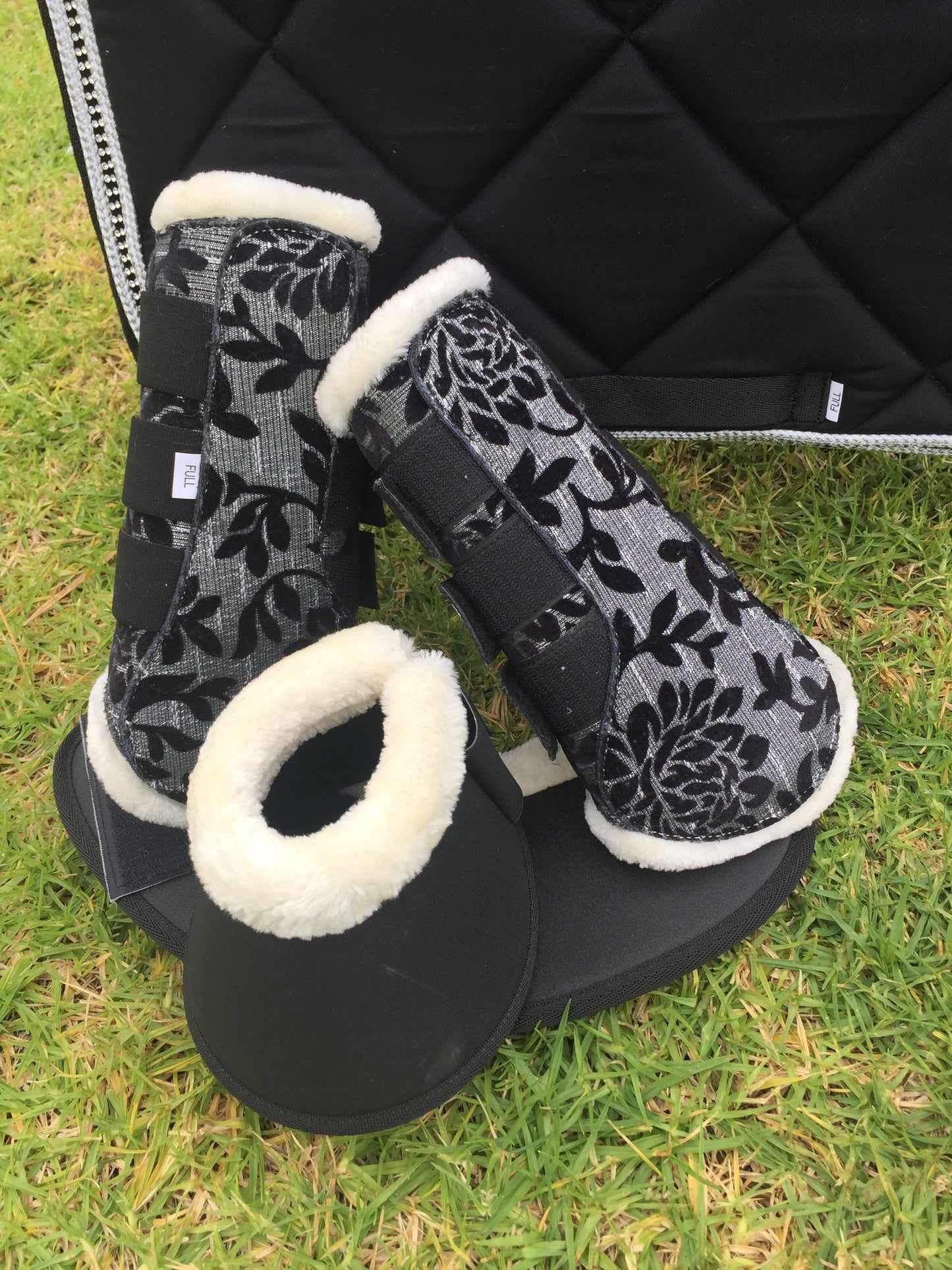 Black and silver brushing boots